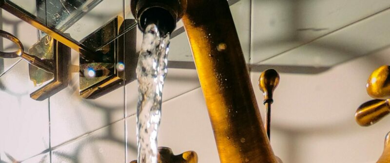 Water coming out of a sink faucet. 