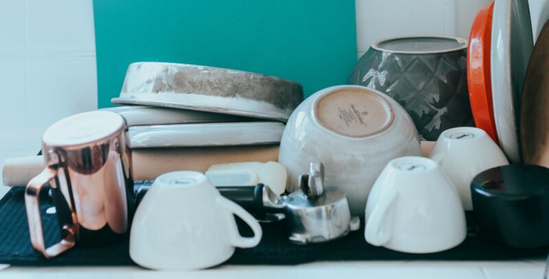 A pile of dishes drying after being washed.