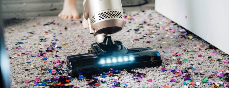 Vacuuming glitter from a rug.